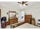 Bright bedroom with a wooden bed frame and two wooden dressers and neutral carpet at 7587 Winding Way, Fishers, IN 46038
