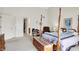 Inviting bedroom boasts a canopy bed, ample space, and neutral tones for relaxation at 7587 Winding Way, Fishers, IN 46038