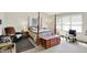 Spacious bedroom showcasing a four-poster bed, natural light, and comfortable furniture at 7587 Winding Way, Fishers, IN 46038