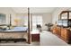 Bedroom featuring a four-poster bed, dresser, and natural light, creating a cozy retreat at 7587 Winding Way, Fishers, IN 46038