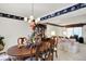 Dining area with wood table, cushioned chairs, decorative wallpaper border, chandelier and living space at 7587 Winding Way, Fishers, IN 46038