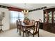 A formal dining room displays an oval table, cushioned chairs, china cabinet, and natural light through window at 7587 Winding Way, Fishers, IN 46038