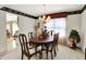 Traditional dining room featuring an oval table, cushioned chairs, and decorative floral arrangements at 7587 Winding Way, Fishers, IN 46038