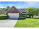 Charming two-story home featuring brick accents, attached garage, and well-manicured lawn at 7587 Winding Way, Fishers, IN 46038