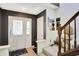 Foyer with stair lift, white french doors, decorative wallpaper and tiled floors at 7587 Winding Way, Fishers, IN 46038