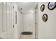 Bright hallway with white doors and neutral tile flooring, leading to various rooms and storage closets at 7587 Winding Way, Fishers, IN 46038