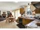 Open-concept kitchen blends wood cabinetry, appliances, and dining nook, with access to Gathering room at 7587 Winding Way, Fishers, IN 46038