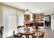 Kitchen and eat-in dining area with wood table and chairs, oak cabinets, and natural light from window at 7587 Winding Way, Fishers, IN 46038