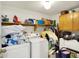 Functional laundry room equipped with a washer, dryer, shelving, and storage space for laundry essentials at 7587 Winding Way, Fishers, IN 46038