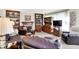 Inviting living room with a fireplace, built-in bookcases, comfortable leather furniture, and ample natural light at 7587 Winding Way, Fishers, IN 46038