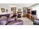 Comfortable living room with a fireplace, built-in bookcases, and leather furniture for relaxation and entertainment at 7587 Winding Way, Fishers, IN 46038