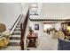 Living room with carpeted floors, stair lift, and classic décor at 7587 Winding Way, Fishers, IN 46038