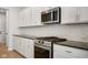 Close up of a modern kitchen featuring stainless steel appliances and clean white cabinets at 786 James William Ln, Westfield, IN 46074