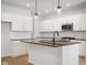 Beautiful kitchen featuring white cabinets, subway tile backsplash, stainless steel appliances, and a center island at 786 James William Ln, Westfield, IN 46074