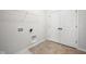 Well-lit laundry room with connections for washer/dryer and storage shelving at 786 James William Ln, Westfield, IN 46074