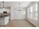 Open-concept room featuring kitchen island, dining area, and bright windows facing the outside at 786 James William Ln, Westfield, IN 46074