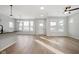 Open-concept living room with hardwood floors and a view of the kitchen island and bright windows at 786 James William Ln, Westfield, IN 46074