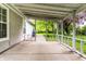 This back porch has a concrete floor overlooking the backyard at 9118 Hardwood Ct, Indianapolis, IN 46250