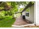 Lovely backyard featuring a covered patio, brick fire pit, and lush greenery, creating an inviting outdoor living space at 9118 Hardwood Ct, Indianapolis, IN 46250