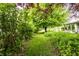 Idyllic backyard path with lush vegetation, leading to the home's screened porch, perfect for tranquil outdoor living at 9118 Hardwood Ct, Indianapolis, IN 46250
