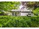 Home with a covered porch and mature landscaping, offering a serene outdoor living space and curb appeal at 9118 Hardwood Ct, Indianapolis, IN 46250