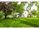 Beautifully landscaped backyard with mature trees and a covered patio, perfect for outdoor entertaining and relaxation at 9118 Hardwood Ct, Indianapolis, IN 46250