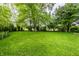 Spacious, verdant backyard with mature trees, providing shade and privacy for outdoor activities and relaxation at 9118 Hardwood Ct, Indianapolis, IN 46250