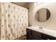 Bathroom sink and shower with modern black cabinets and vanity at 9118 Hardwood Ct, Indianapolis, IN 46250