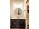 Bathroom vanity with mirror, dark brown cabinets and modern lights at 9118 Hardwood Ct, Indianapolis, IN 46250