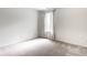 This bedroom has a large window, curtains, and carpeted floors at 9118 Hardwood Ct, Indianapolis, IN 46250