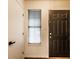 Clean entryway featuring a front door with a window and adjacent coat closet, illuminated by natural light at 9118 Hardwood Ct, Indianapolis, IN 46250