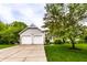 Traditional home showcasing a two-car garage, neutral siding, and a lush front yard, perfect for Gathering living at 9118 Hardwood Ct, Indianapolis, IN 46250