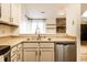 Stainless steel dishwasher and updated fixtures with open views of the living room at 9118 Hardwood Ct, Indianapolis, IN 46250