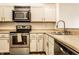 Cozy kitchen features a stainless steel oven, microwave, and white cabinets at 9118 Hardwood Ct, Indianapolis, IN 46250