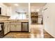 Kitchen sink and counter with stainless steel dishwasher and cozy view into the living area at 9118 Hardwood Ct, Indianapolis, IN 46250
