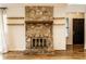 Inviting living room featuring a stone fireplace with wood mantle and shelving, plus natural light at 9118 Hardwood Ct, Indianapolis, IN 46250