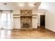 Cozy living room boasting a stone fireplace, floating wood shelves and wood floors at 9118 Hardwood Ct, Indianapolis, IN 46250