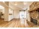 Open-concept living space featuring a stone fireplace, wood floors, and natural light, perfect for entertaining at 9118 Hardwood Ct, Indianapolis, IN 46250