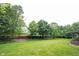 Expansive backyard with lush green lawn, mature trees, and a privacy fence, perfect for outdoor activities at 9127 Pointe Ct, Fishers, IN 46037