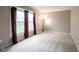 Neutral bedroom featuring a sunlit window, plush carpet, and ample space at 9127 Pointe Ct, Fishers, IN 46037