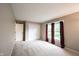 Neutral bedroom featuring a bright window, closet, and plush carpet at 9127 Pointe Ct, Fishers, IN 46037