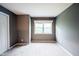 Neutral bedroom featuring grey walls, white trim, and a window offering natural light at 9127 Pointe Ct, Fishers, IN 46037