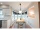 Sunny dining nook features hardwood floors, white trim and cabinetry, and a hanging light fixture at 9127 Pointe Ct, Fishers, IN 46037
