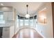 Bright dining nook with hardwood floors and white trim features a hanging light fixture at 9127 Pointe Ct, Fishers, IN 46037