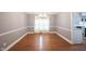 Dining room with hardwood floors, wainscoting and ample natural light from the window at 9127 Pointe Ct, Fishers, IN 46037