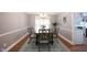 Dining room boasting a modern chandelier, large windows, and stylish decor at 9127 Pointe Ct, Fishers, IN 46037