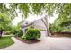 Side view of a home featuring a brick exterior, attached garage, and landscaped garden at 9127 Pointe Ct, Fishers, IN 46037