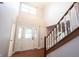 Bright and welcoming foyer with a decorative glass front door, hardwood flooring, and high ceilings at 9127 Pointe Ct, Fishers, IN 46037
