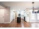 Bright kitchen with center island, stainless appliances, granite counters, white cabinetry, and hardwood floors at 9127 Pointe Ct, Fishers, IN 46037