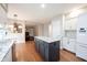 Bright kitchen with center island featuring granite counters, stainless appliances, and modern white cabinetry at 9127 Pointe Ct, Fishers, IN 46037